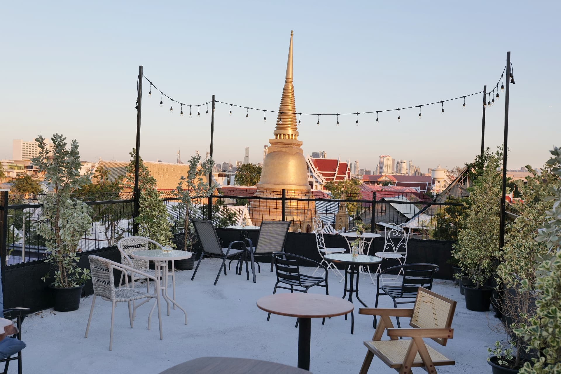 Rooftop terrace at Bud Brew & Beyond with temple views across Bangkok